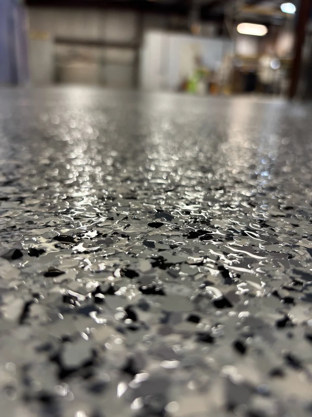 Close-up of a black and white flake floor coating