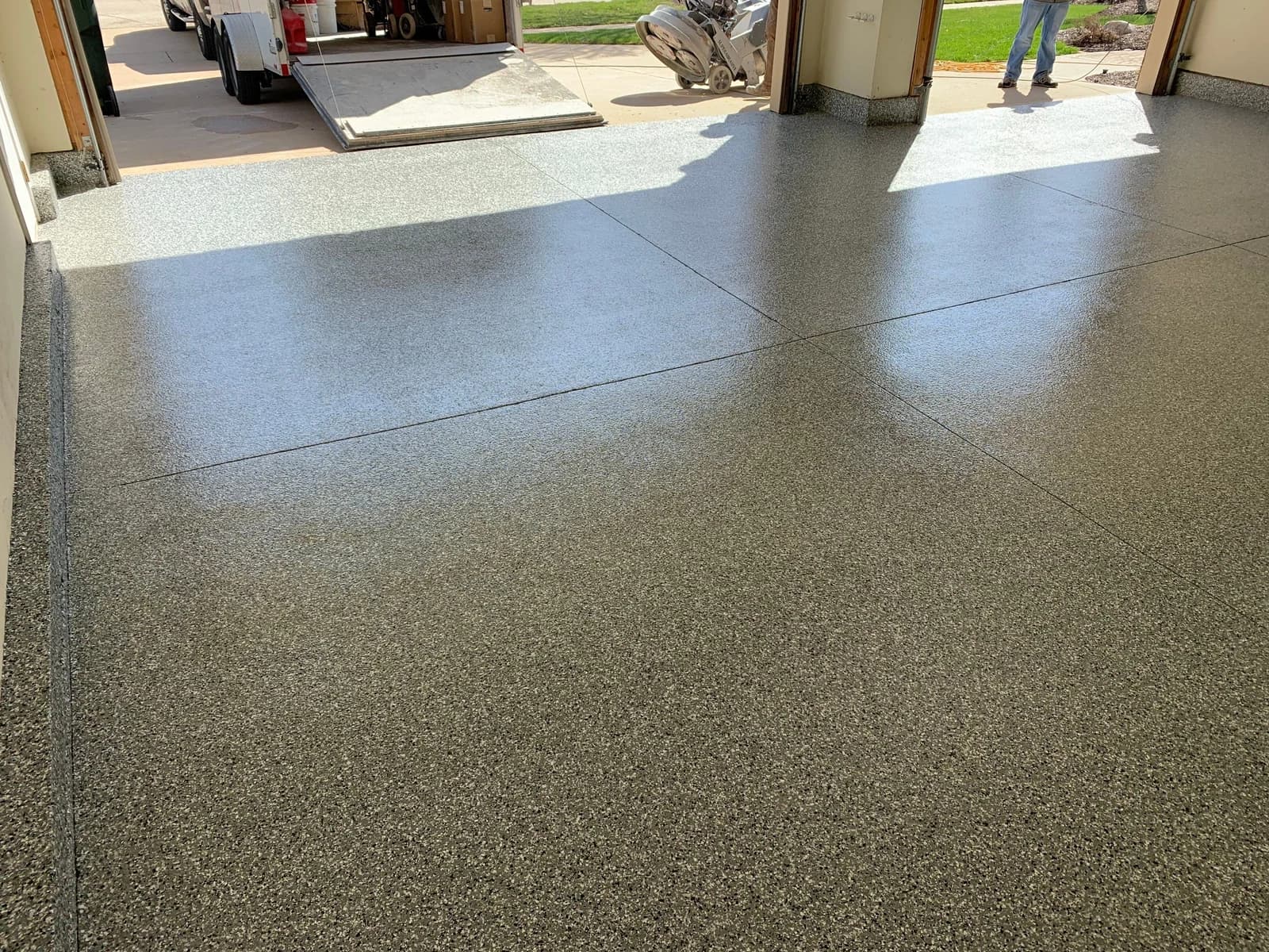 Finished flake garage floor coating seen through an open garage door in Northern Illinois